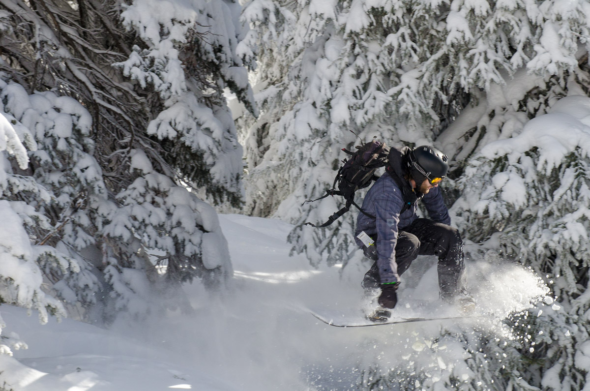 Snowboarder catching air in powder image by Karl Duncan Photography